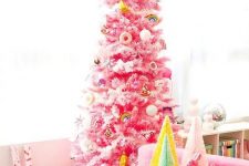 a pink Christmas tree decorated with various bold ornaments food-themed and many others is a fun and cool idea