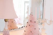 a pink ruffle Christmas tree decorated with tiny metallic ornaments adds a cool and chic glam feel to this vintage space