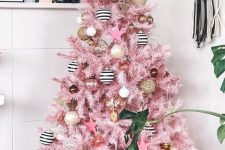 a super glam Christmas tree in pink, with striped, pink and gold ornaments will bring a fun and creative touch to your space