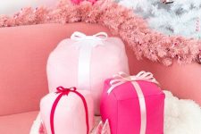 funky pink gift box holiday pillows, a pink fir garland and a hot pink mini Christmas tree decor glam and chic Christmas decor