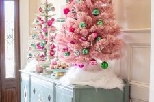 glam Christmas decor with a pink and a silver tinsel tree and green and hot pink ornaments is lovely