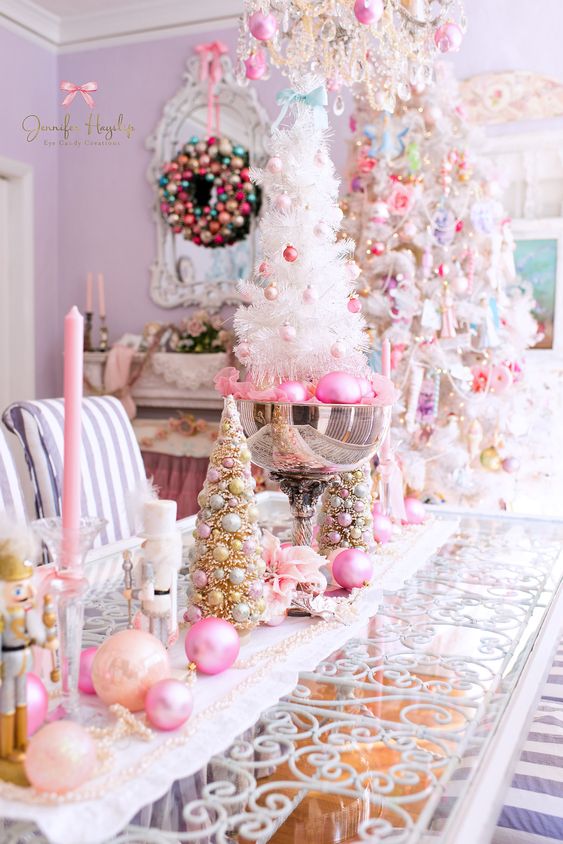 glam Christmas decor with peachy and hot pink ornaments and candles, beads, pink ornaments in a bowl and a white mini tree with blush and pink ornaments