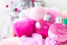 hot pink Christmas ornament pillows and a faux fur blanket plus matching ornaments on the silver Christmas tree
