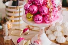 hot pink Christmas ornaments in a cloche will become a lovely Christmas centerpiece or a decoration for a dessert table