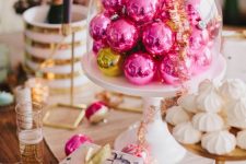 hot pink Christmas ornaments in a cloche will become a lovely Christmas centerpiece or a decoration for a dessert table