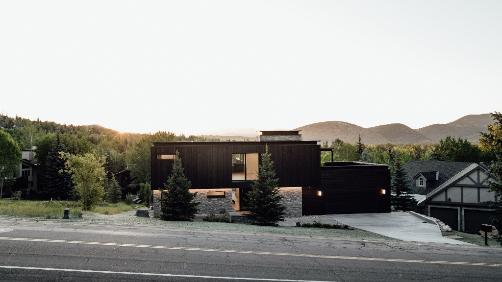 01 This stylish contemporary house is clad with charred wood and is built on the slopes