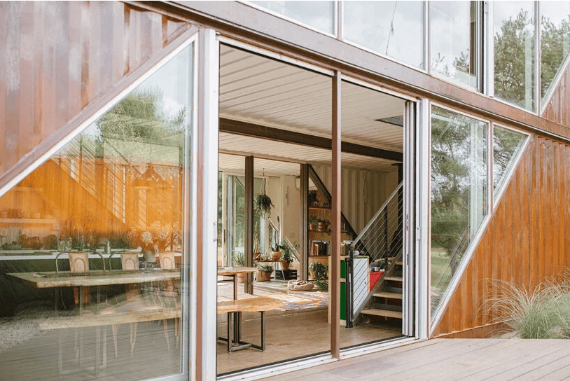 The doors are sliding and they help the indoor spaces merge with outdoor ones