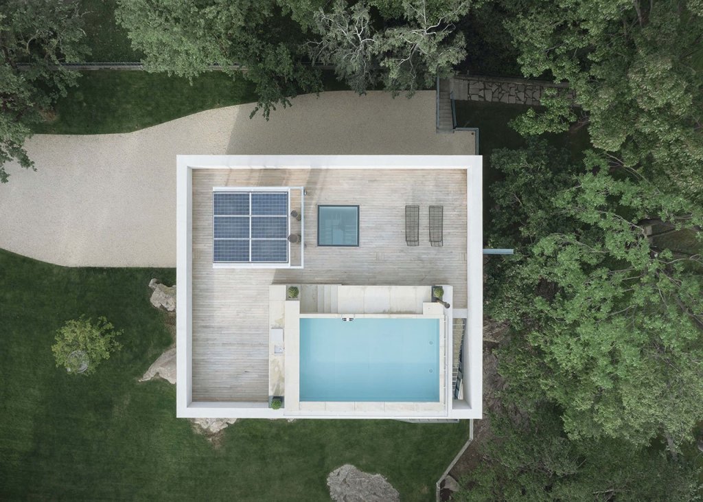 The roof features a terrace with a pool, some loungers, photovoltaic panels and a cool view