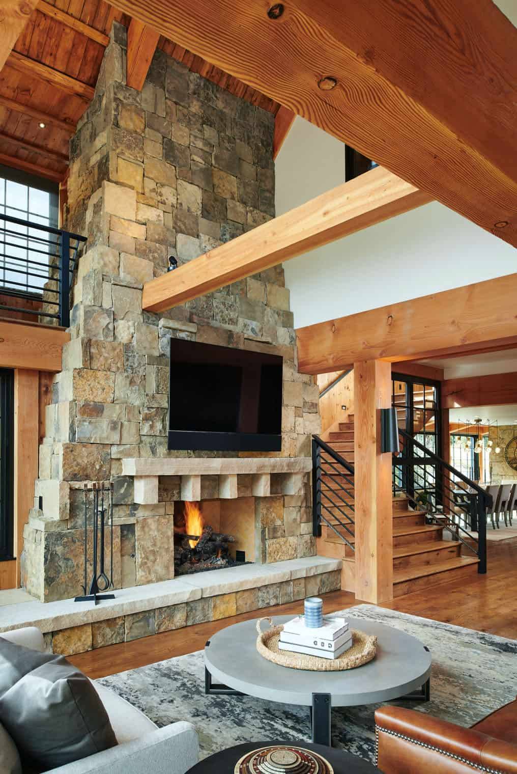 04 The living room shows off a cool two-story stone fireplace, and that is a centerpiece