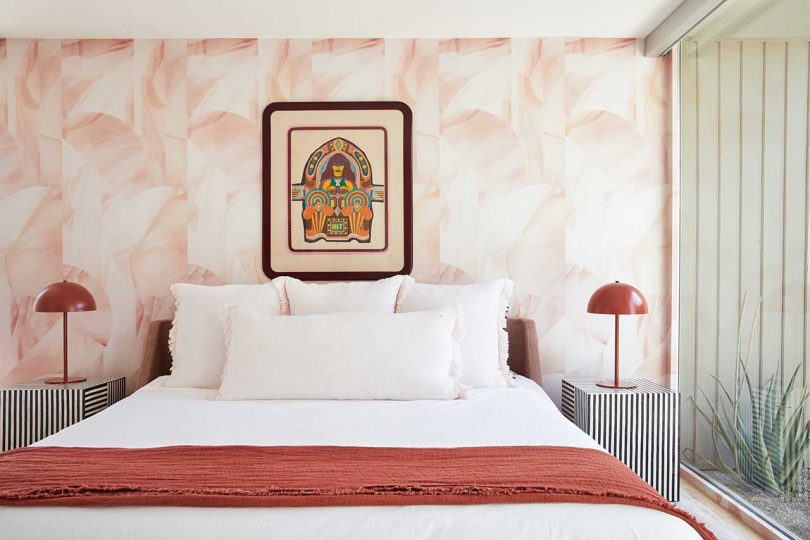 Another bedroom is done with reddish shades, with quirky furniture and art