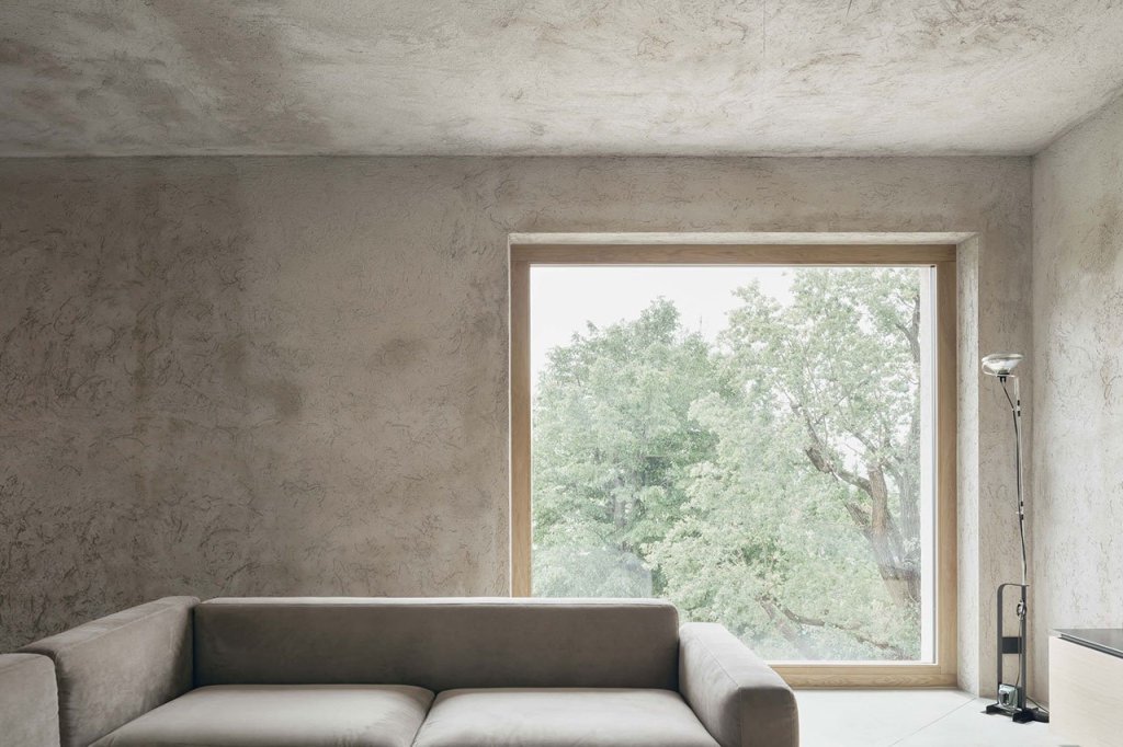 The living room features nothing but minimalist furniture and lamps and amazing views