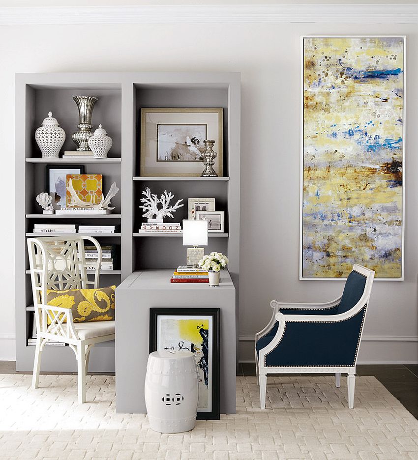 an elegant home office with dove grey walls, a built-in storage unit with a built-in desk, a couple of chairs and a statement artwork