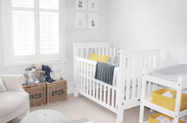 an ethreal dove grey nursery with elegant white furniture, grey textiles, a mustard toy car and some more yellow details