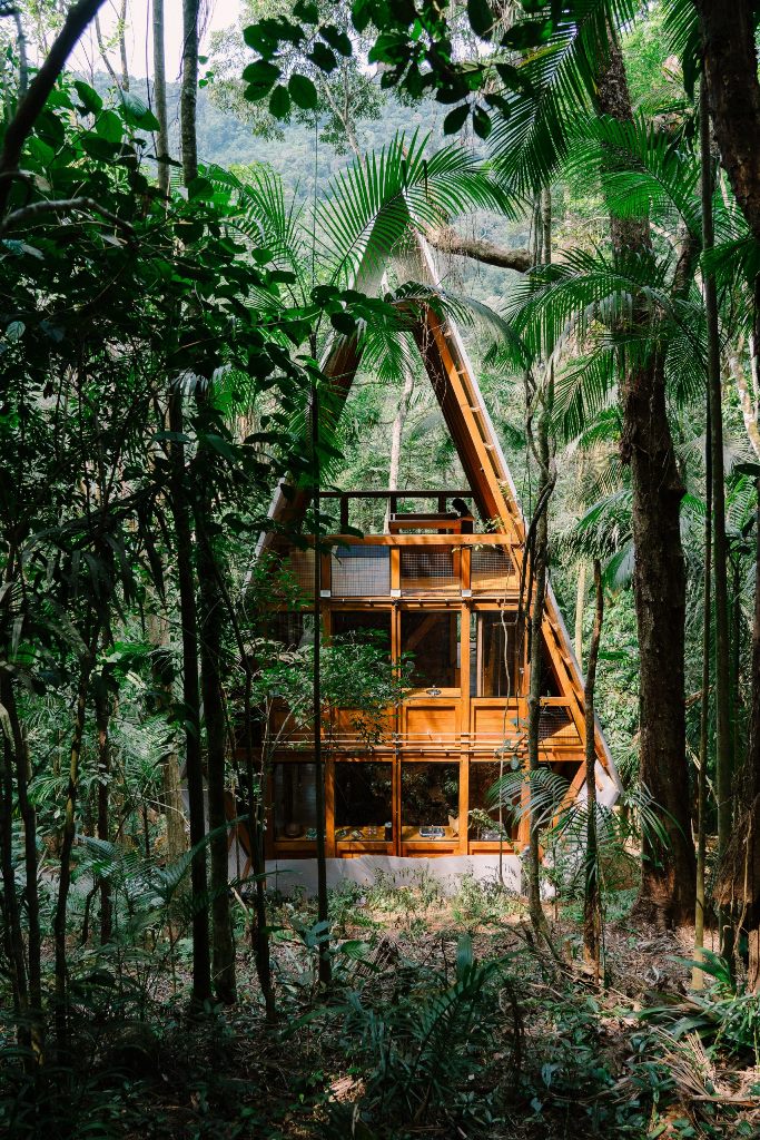 This cabin is built deep inside Brazilian forests, it features a wooden frame and a metal roof