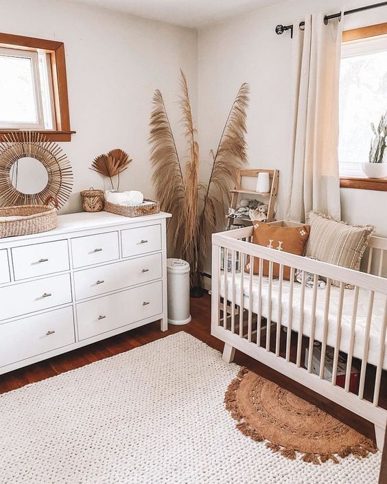 02 a gender neutral boho nursery with pampas grass, white furniture, layered rugs and neutral textiles is a chic space