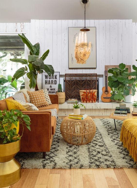 a global style living room with boho influence, done in warm tones, potted greenery and cool accessories