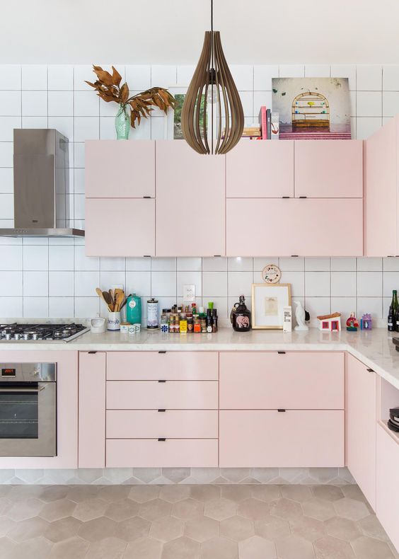 04 a modern pastel kitchen done in soft pink, with a catchy pendant lamp and a white square tile backsplash