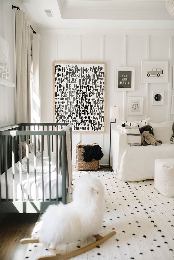 04 a stylish monochromatic nursery with graphit artworks, a green crib, printed textiles is welcoming