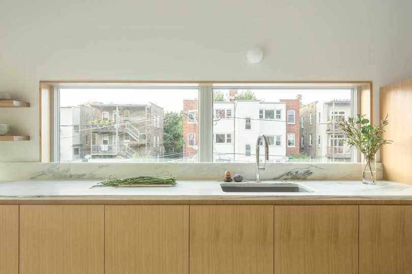 A backsplash is substituted with a window to fill the kitchen with natural light as much as possible