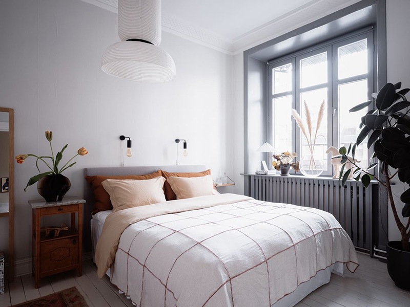 06 The bedroom is done in mostly white and grey, there’s cool and comfy furniture and you may see printed bedding