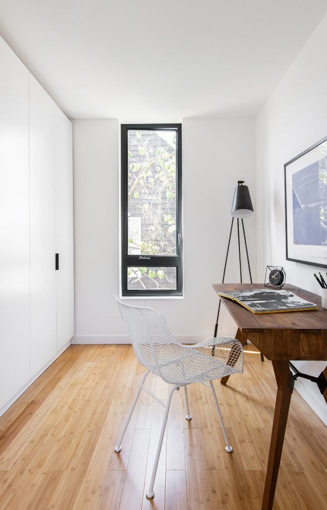 The workspace is done with sleek wardrobes, a vintage desk and a metal chair