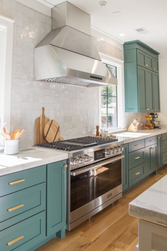 07 a beautiful teal kitchen with white stone countertops and a white tile backsplash and touches of gold looks bold