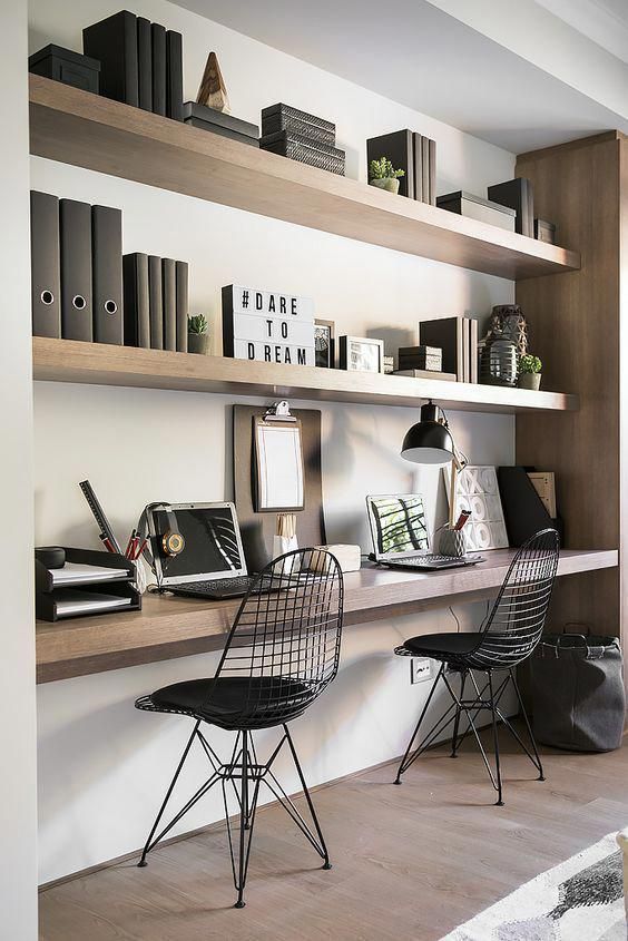 07 a stylish minimalist home office with floating shelves and a shared desk, metal chairs, table lamps and books