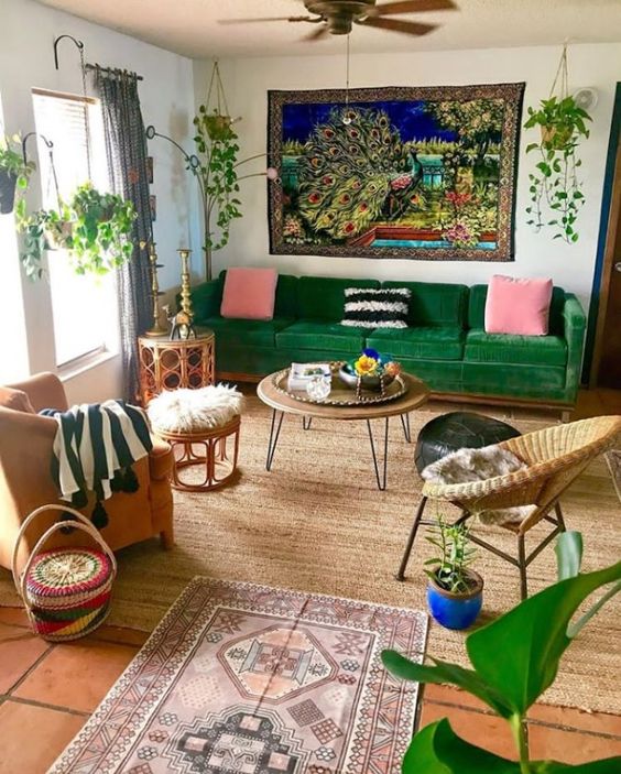 a colorful maximalist living room with boho touches, bright textiles, potted greenery and wicker furniture