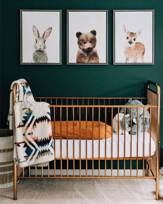 12 a green nursery with a wildlife gallery wall, a chic brass crib and printed textiles is very cozy