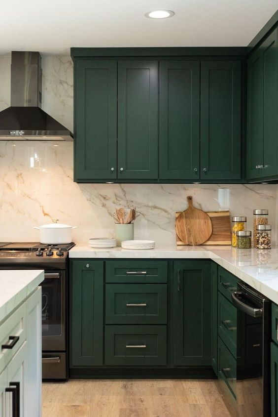 14 an elegant hunter green kitchen with a white marble backsplash and countertops and a white kitchen island for a contrast