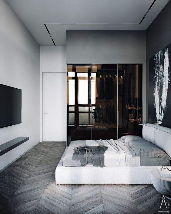 a minimalist master bedroom with a part of it taken by a closet in brown glass is very chic and refined