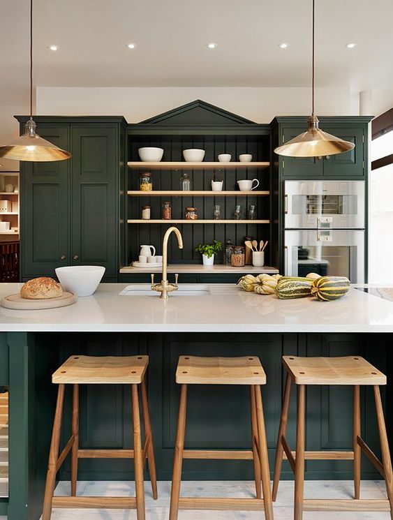 17 a sophisticated hunter green kitchen with vintage cabinets, open shelves, white countertops, metal pendant lamps and wooden stools