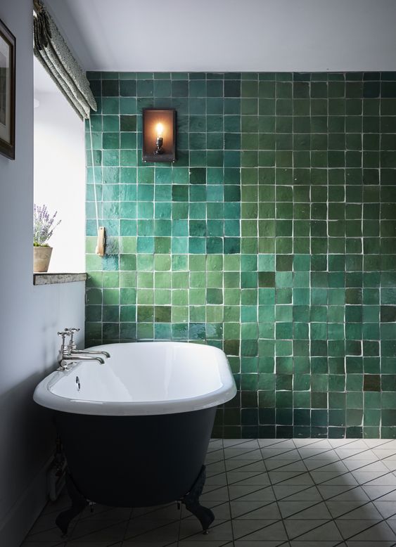 19 a catchy and refined bathroom with a statement wall done with tiles of various shades of green