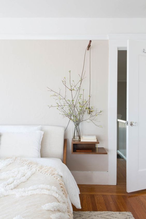 a calming and welcoming bedroom with a floating sleek nightstand with storage space is amazing