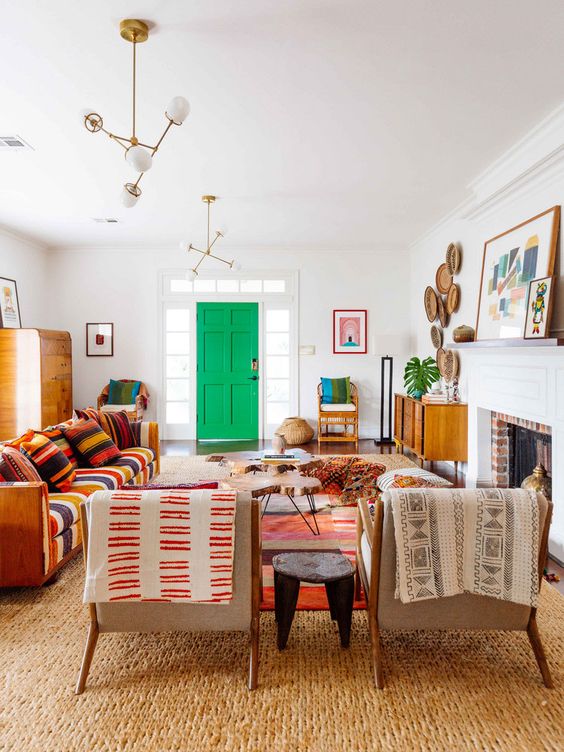 a colorful global style living room with bright printed folksy textiles, decorative plates and bright artworks
