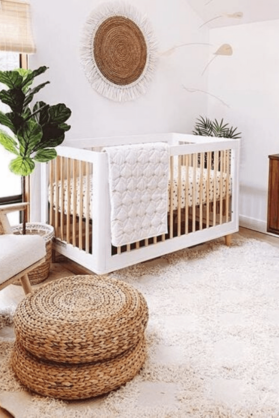 20 a neutral boho nursery with white furniture, jute ottomans, potted plants and a lovely jute decoration