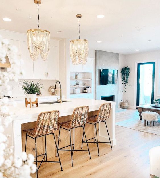 amazing wooden bead chandeliers, rattan stools make this white kitchen glam, chic and very outstanding