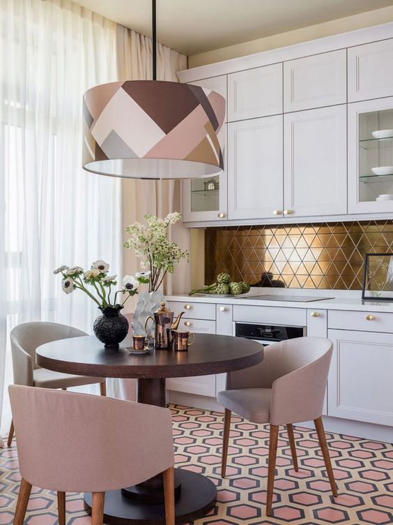 a modern glam kitchen in white, with a gold geometric backsplash and a catchy geometric pendant lamp to rock