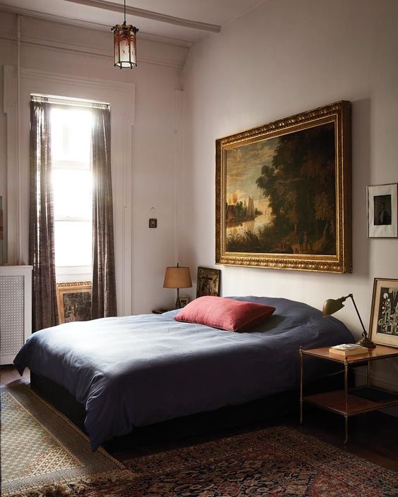 26 a refined old world bedroom with a comfy bed and nightstands, beautiful artworks, table lamps and printed textiles