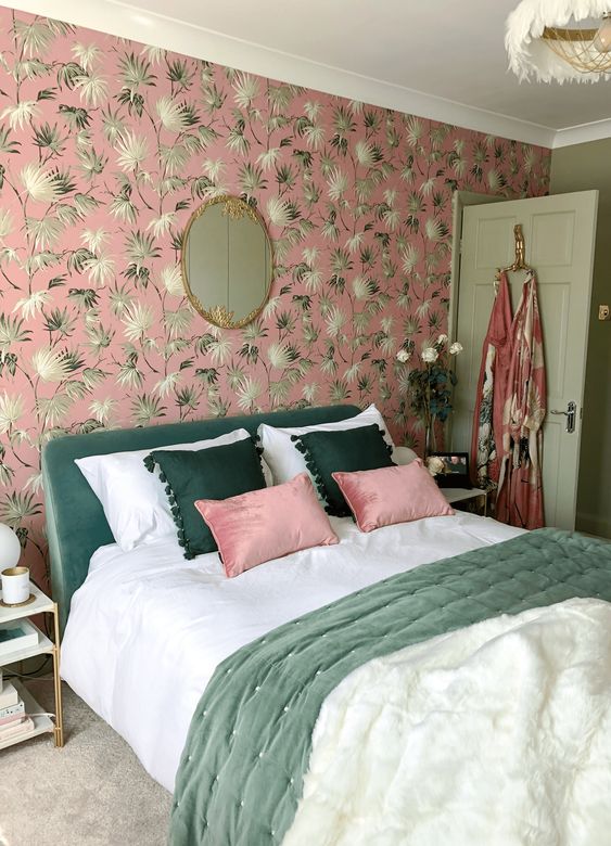 36 a glam and cool bedroom with a pink botanical wall, a green bed, green and pink pillows and a feather chandelier