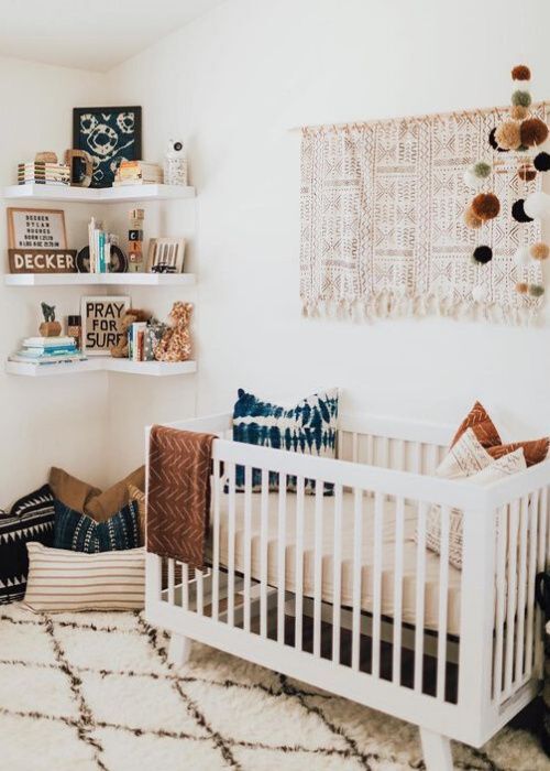 an earthy tone nursery done with neutrals and indigo blue, with printed textiles and open shelves