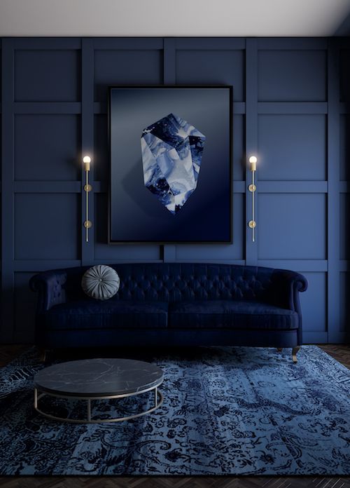 an exquisite navy living room with a refined midnight blue sofa, a cool artwork and a marble coffee table