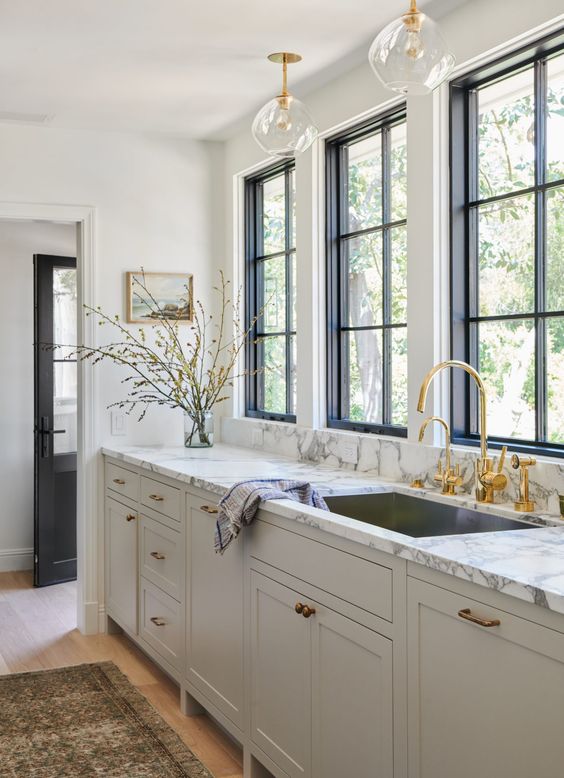 40 a refined greige kitchen with a white marble countertop and gold fixtures and a faucet is a stylish idea