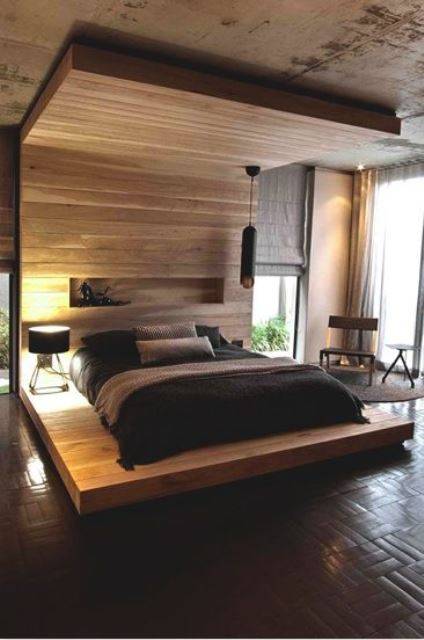 a Japandi bedroom with a statement bed with a canopy over the bed clad with wood and a niche for storage