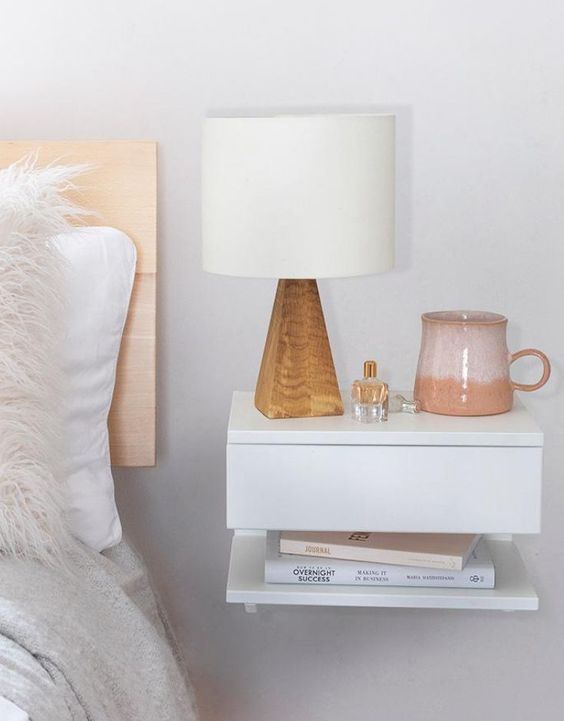 a floating nightstand with a drawer and an open shelf is a lovely idea to save some floor space
