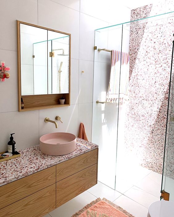 53 a chic contemporary bathroom with a pink terrazzo wall in the shower, a floating vanity with a pink terrazzo countertop plus a pink sink