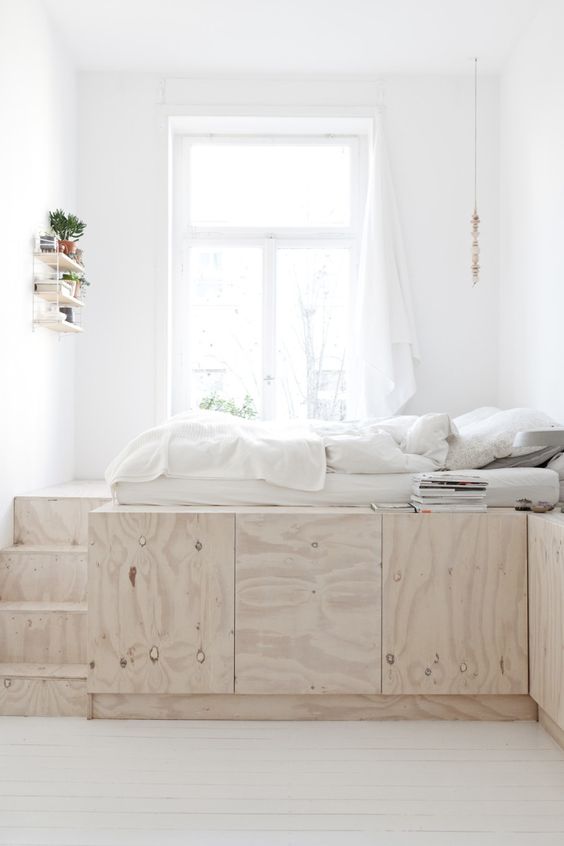 53 a minimalist bedroom in white with a storage platform that doubles as a bed doesn’t have any clutter