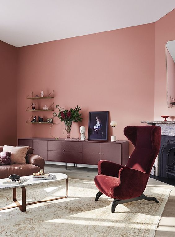 60 a pink living room complemented with a purple sideboard and a burgundy chair plus gold touches