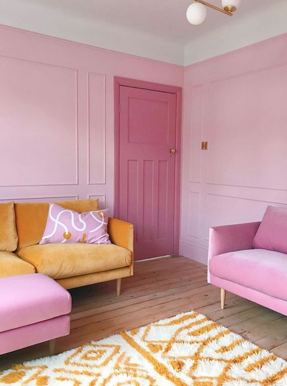 61 a bright pink living room with a yellow sofa and bold pink chairs, a bold pink door is super cool