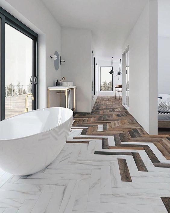67 a refined bathroom with wood and white marble tiles with a chevron pattern, a chic tub by the glazed wall